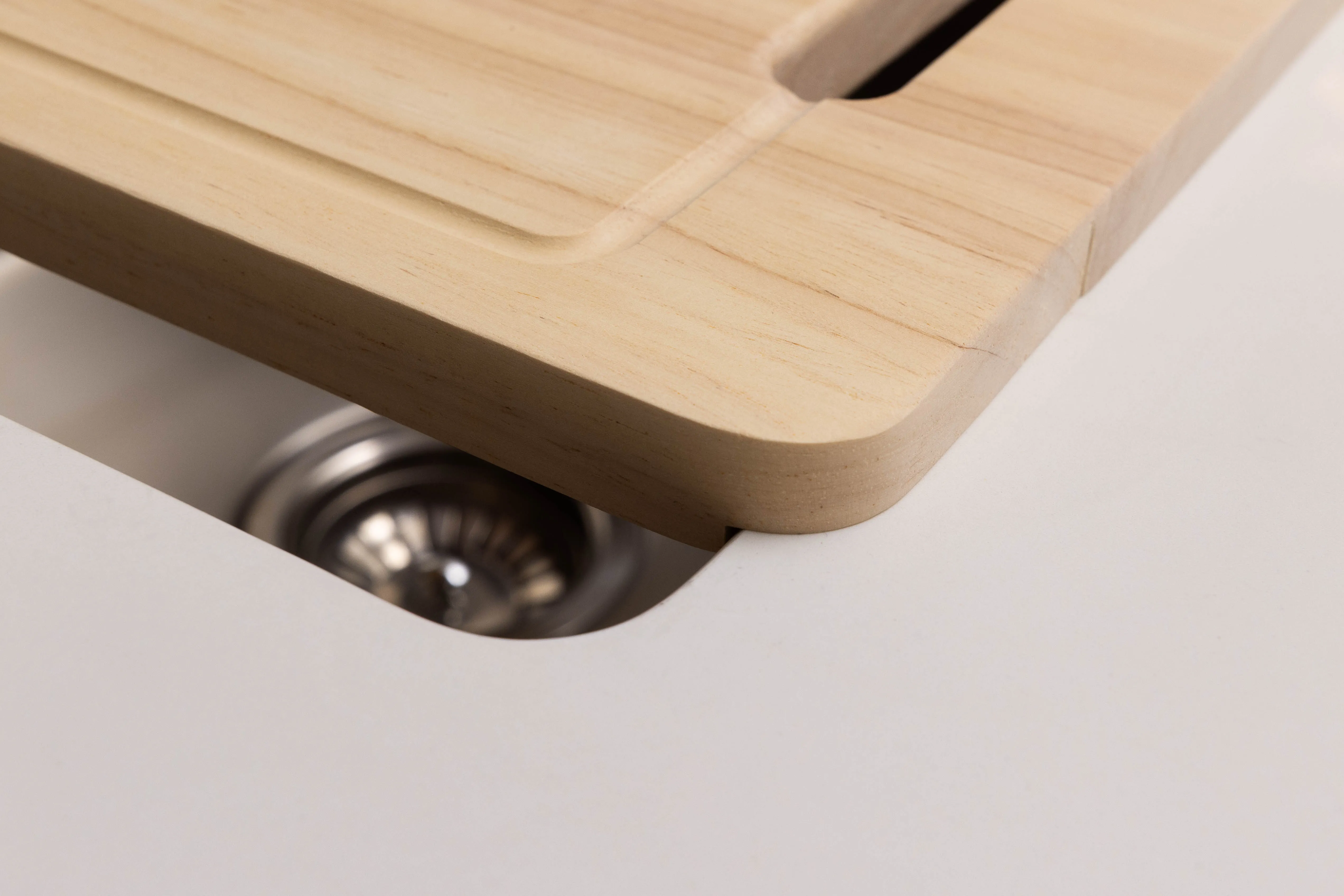 Oak chopping board fitted over a Lucino kitchen sink