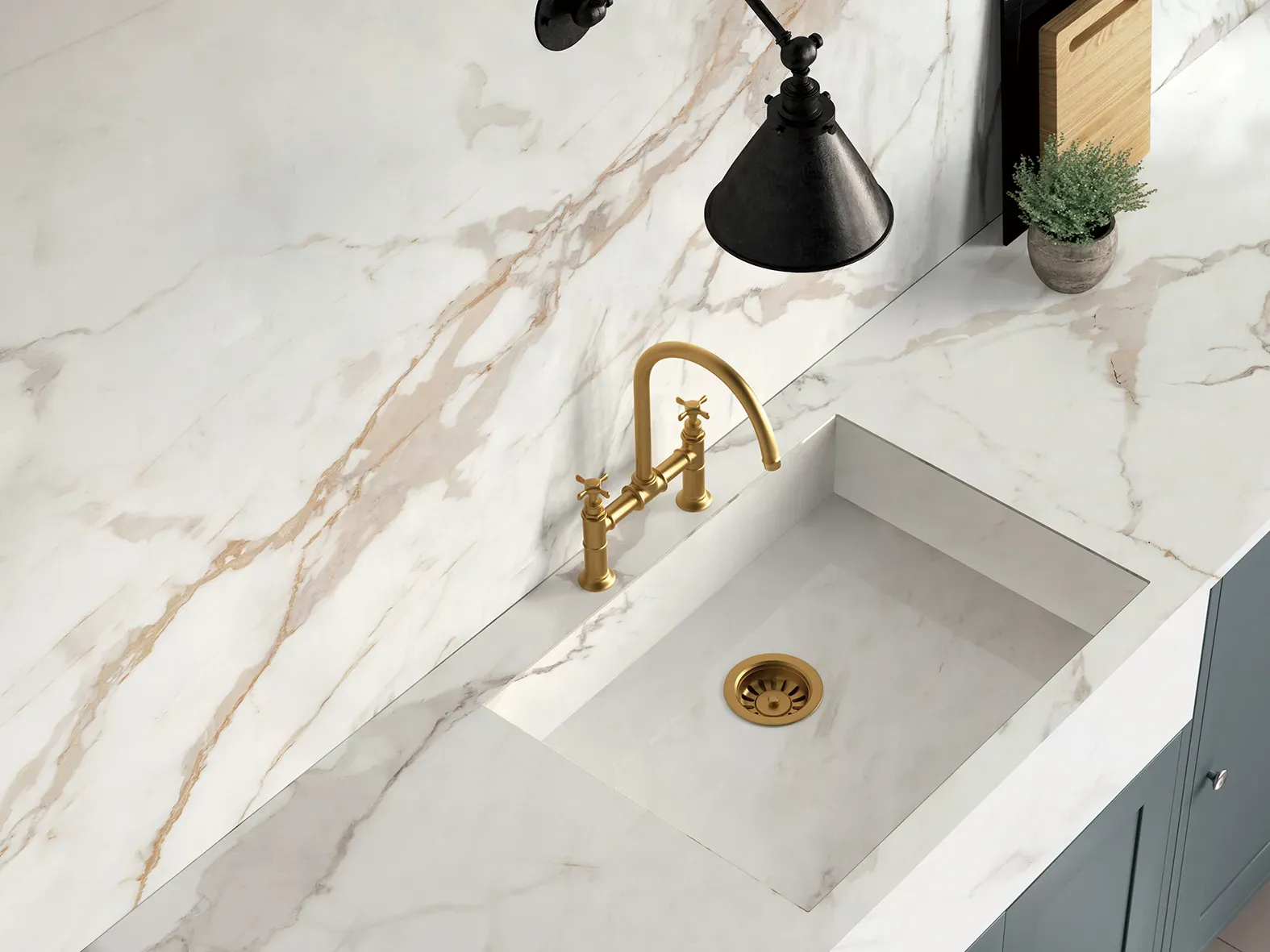 Calacatta Golden countertop and splashback surrounding a white sink
