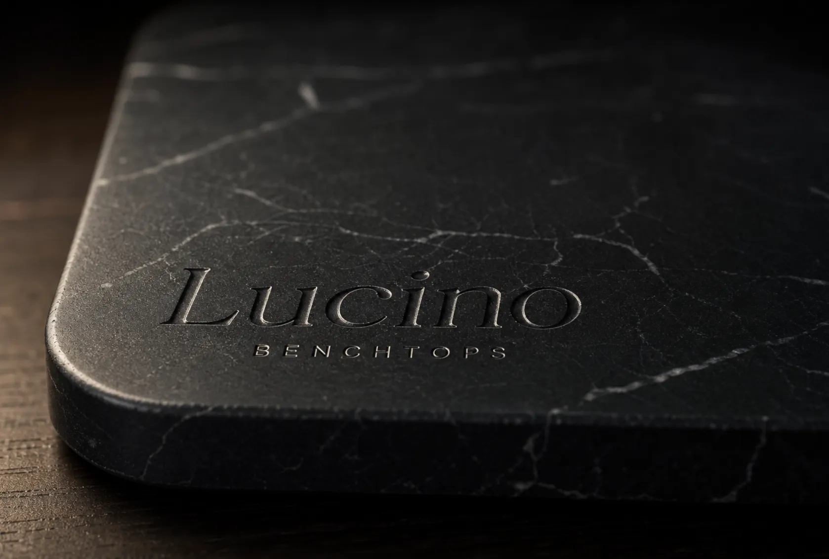 Lucino name engraved into a dark veined stone slab