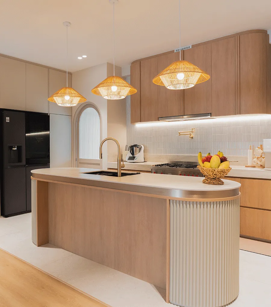 Warm timber kitchen with a curved pale stone island