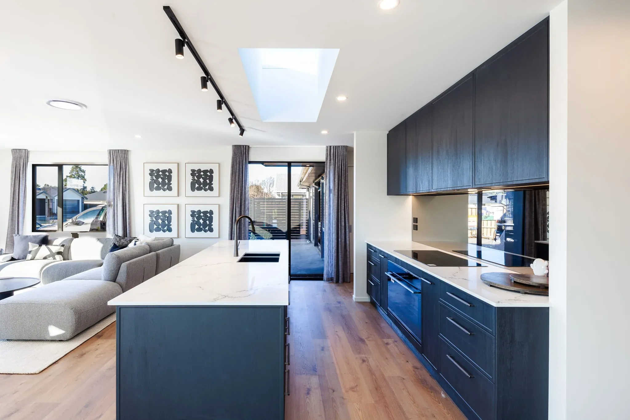Trendsetter Homes kitchen featuring a long Hellenic stone island and matching perimeter benchtop